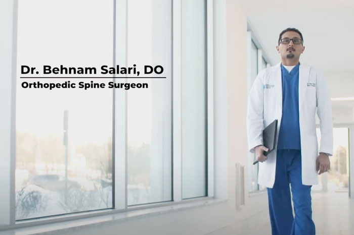 Dr. Behnam Salari, orthopedic spine surgeon in Morristown, NJ, introduces himself in a hospital.